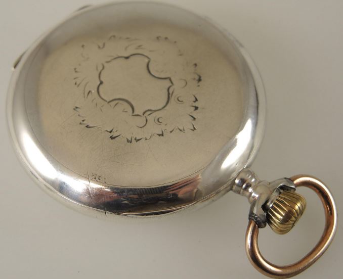 Antique silver omega pocket watch, case back.