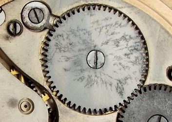 Antique watch damage to a movement due to exposure to water. Pitting..