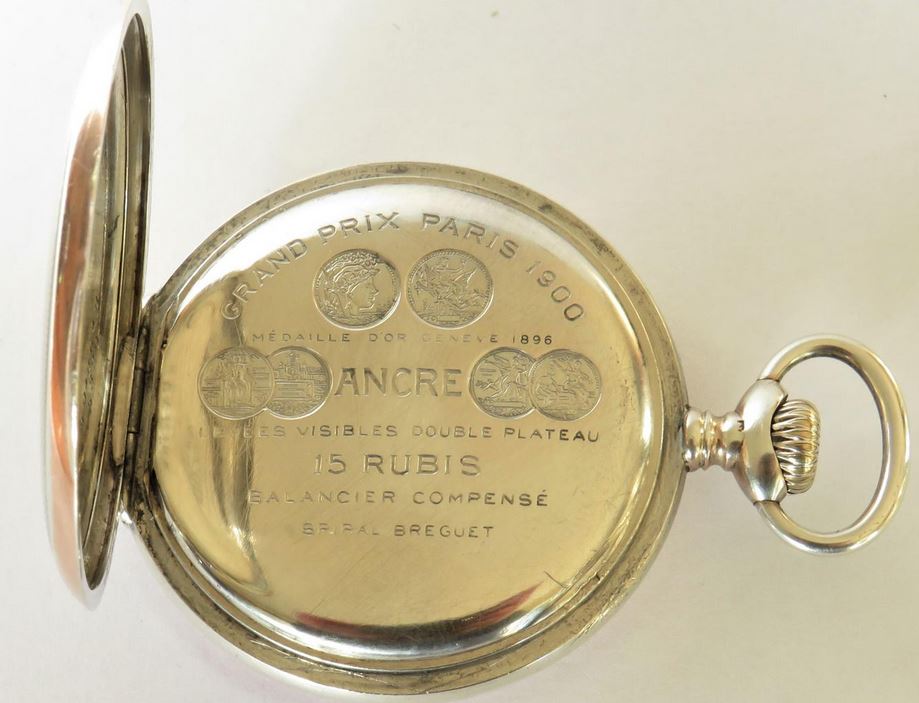 Image of Ancre engraving the on back of pocket watch. Link to antique Zenith pocket watch.
